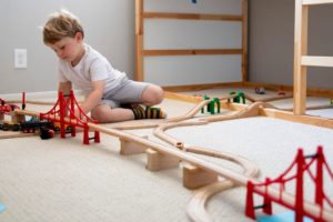 GettyImages-1224710847 boy playing with train set