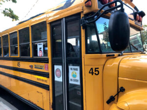 School bus with sign, No mask, No entry, Queens, New York